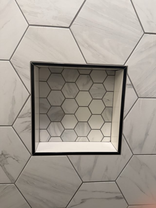 marble hexagon tile shower niche close-up