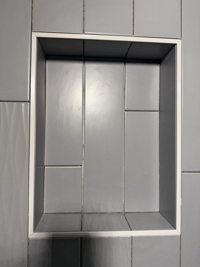 gray tile shower niche close-up