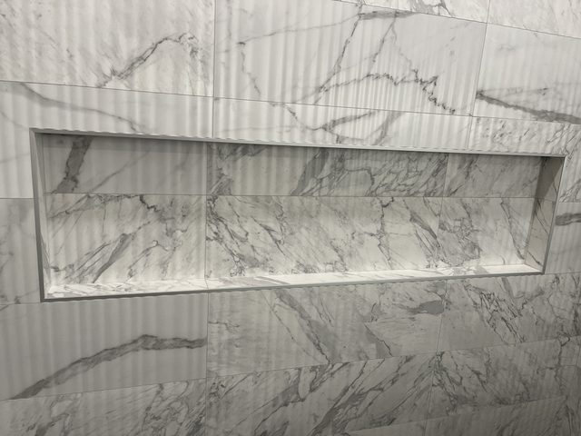 marble shower wall with recessed niche close-up