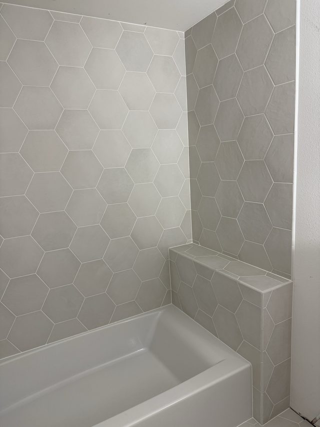 hexagon tile tub surround corner with bathtub and bench