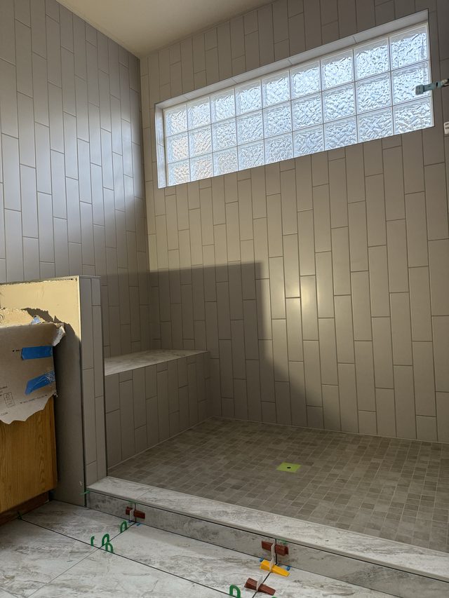 tiled shower with bench seat and glass-block window