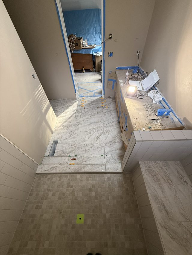 same bathroom renovation, tiled floor and vanity area