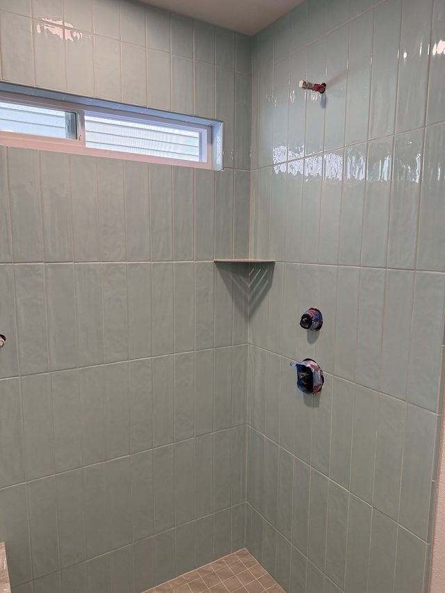 sage green tile walk-in shower walls with corner shelf
