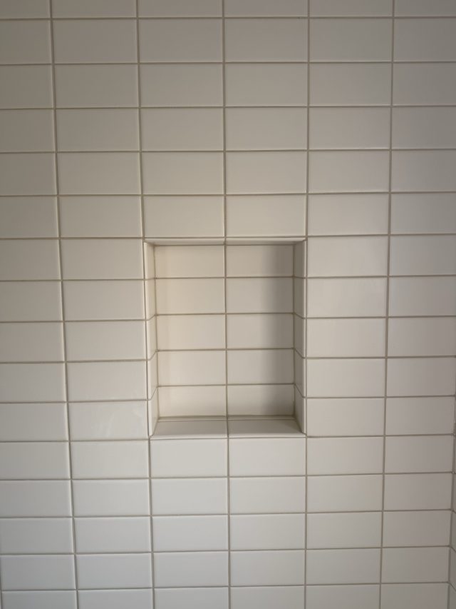 white subway shower wall with recessed niche
