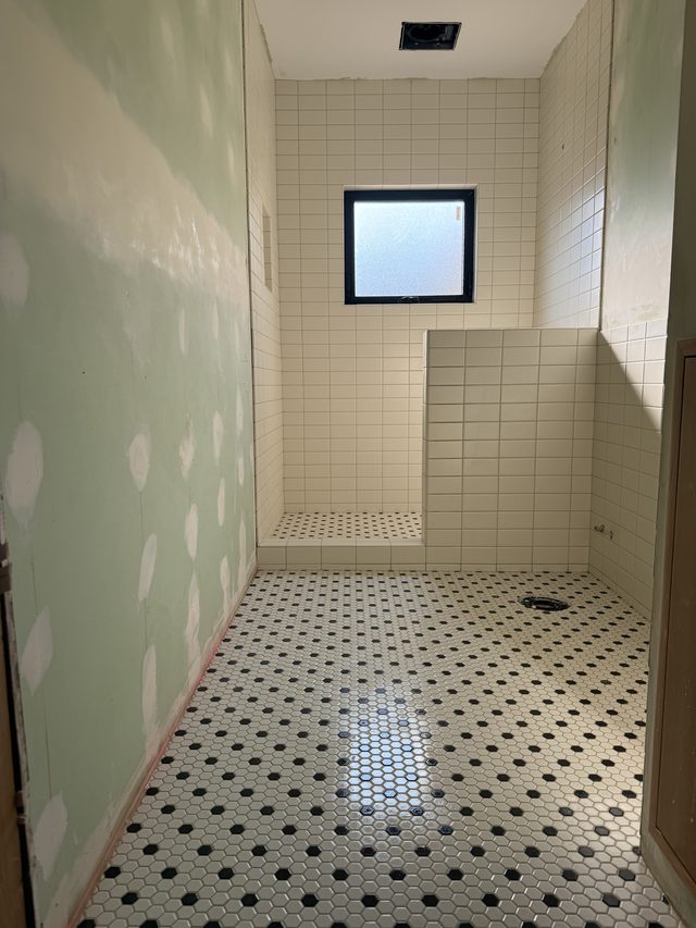bathroom with mosaic floor and tiled shower bench