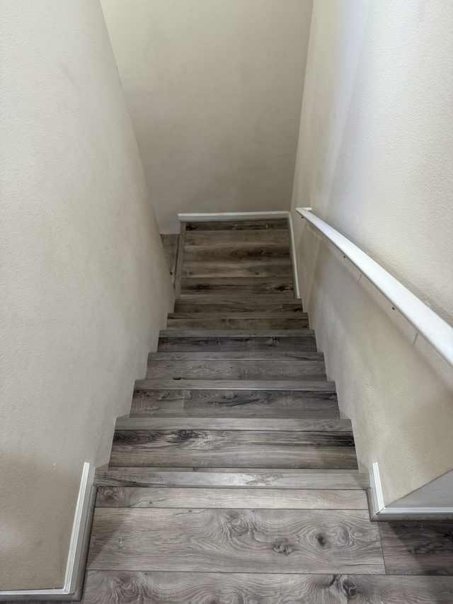 staircase with wood-look plank treads descending