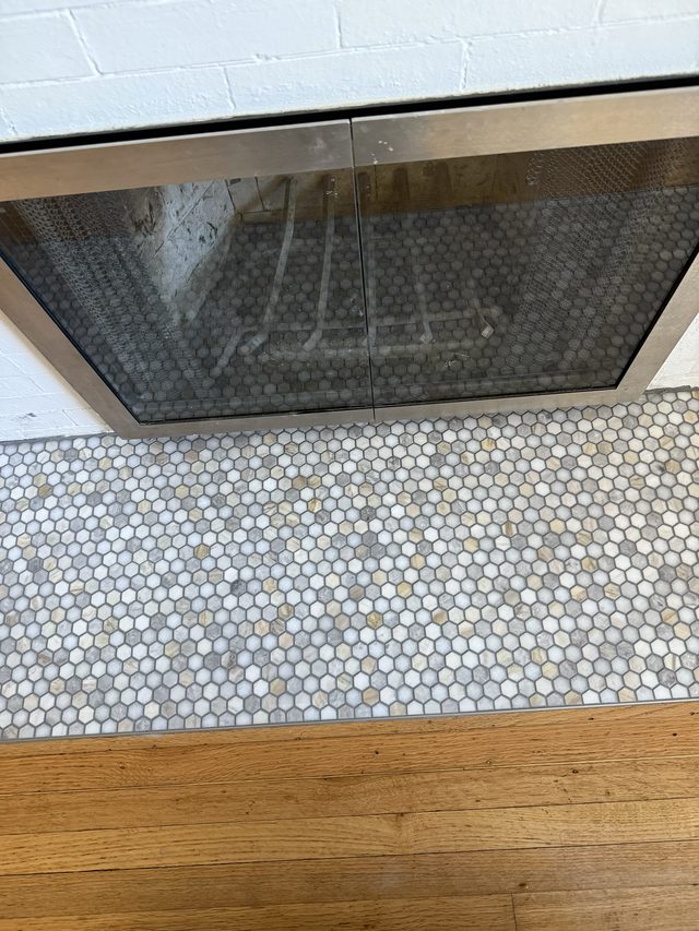 penny-tile hearth floor transitioning to hardwood