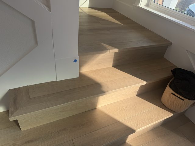 light wood staircase treads and risers with hardwood floor