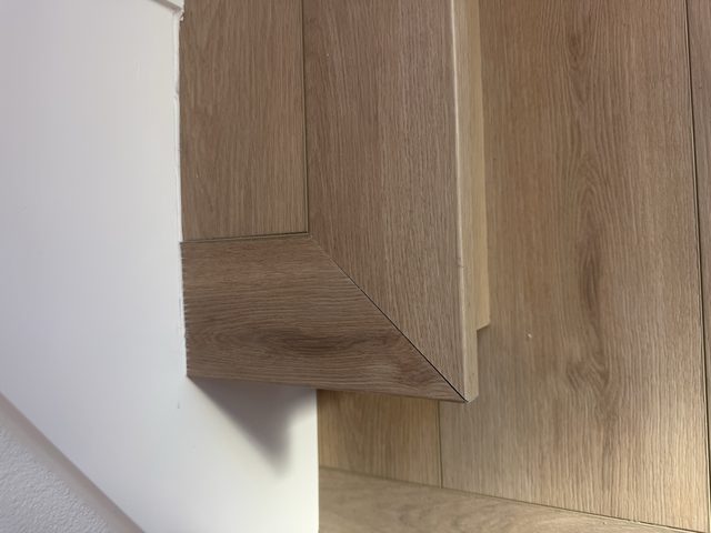 wood stair nosing and floor transition detail close-up