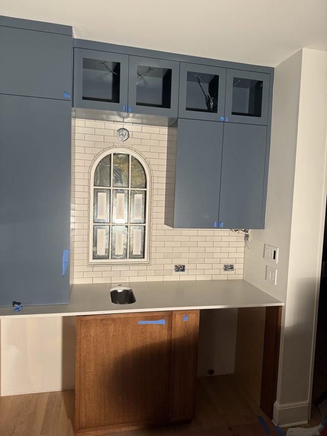 blue cabinets, white subway backsplash, countertop and sink
