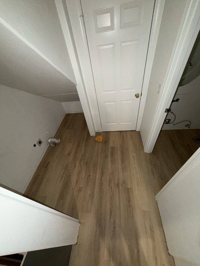 laundry room with vinyl plank floor, dryer vent and washer hookups on wall