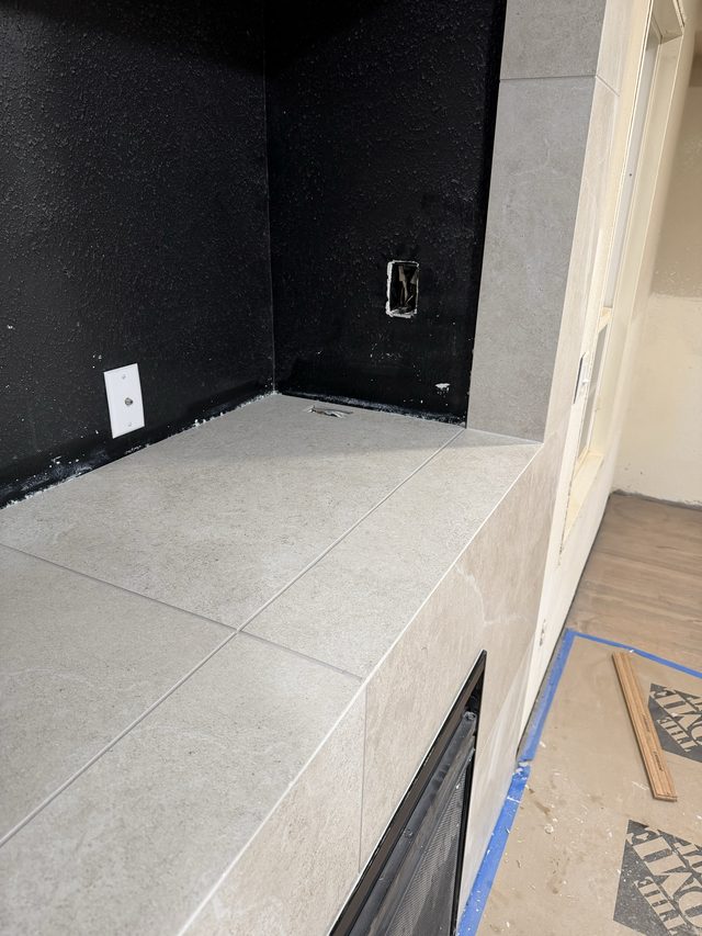 tiled fireplace niche corner with outlet, firebox below