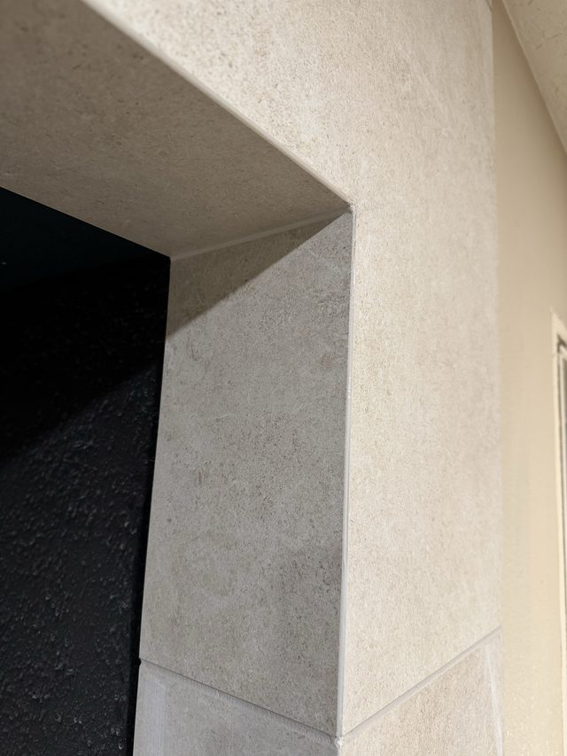 detail of tiled fireplace surround returns and corner