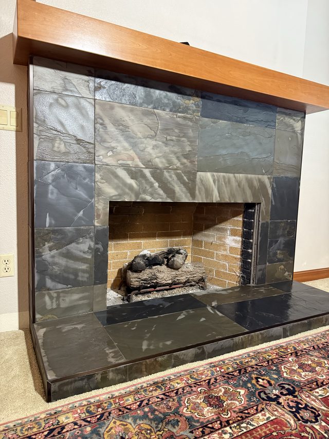 slate-tiled fireplace surround and hearth in living area