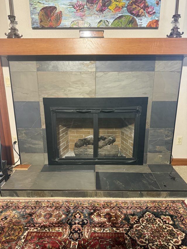 slate-tiled fireplace with black insert