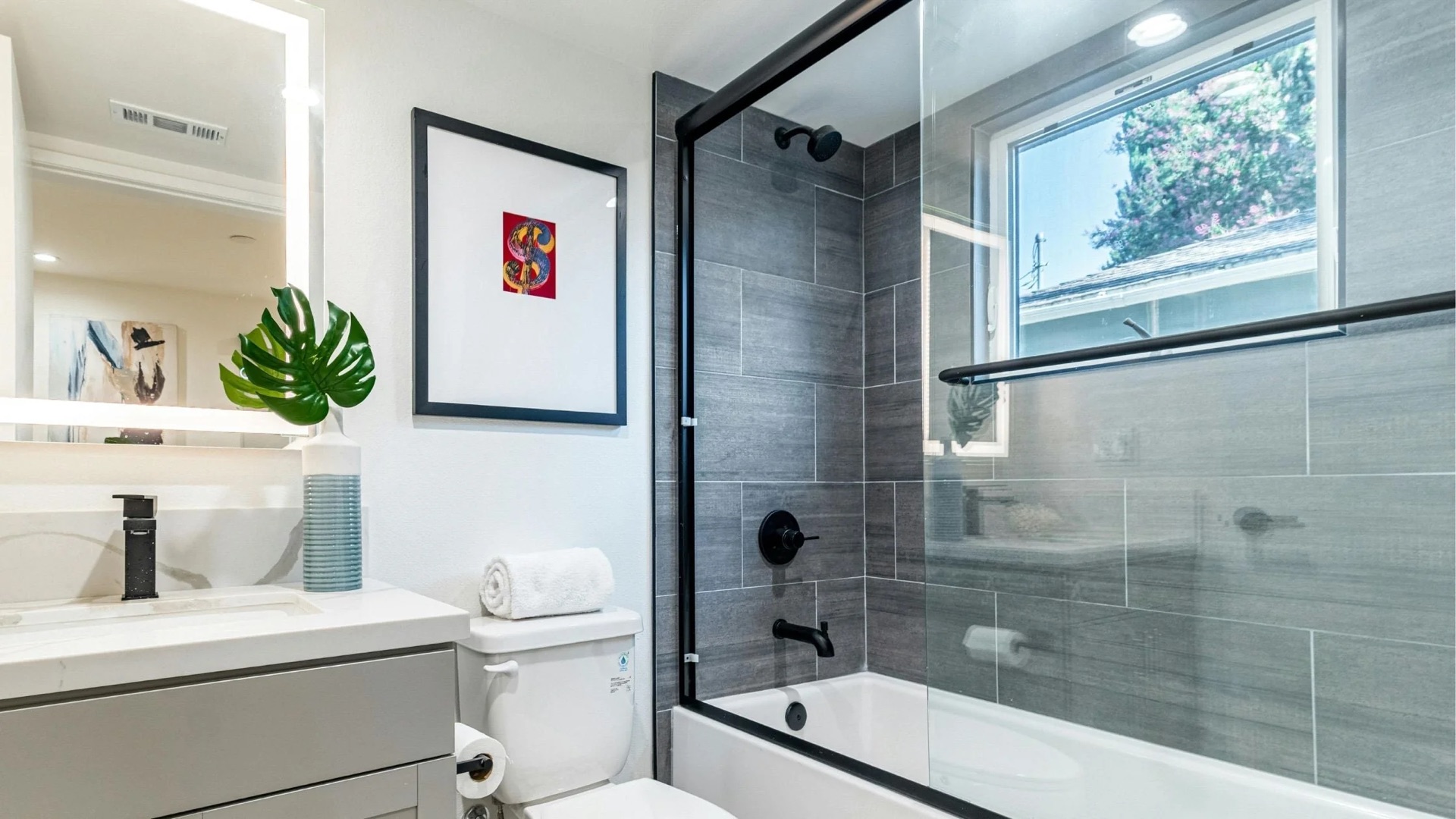 Modern bathroom remodel with custom tile shower and floating vanity by New Style Construction in Portland